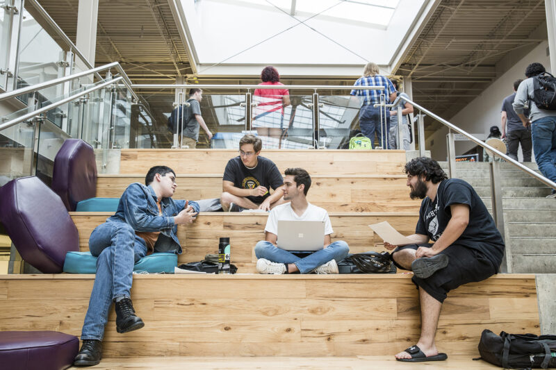 Students study on the social staircase at the Highland campus.